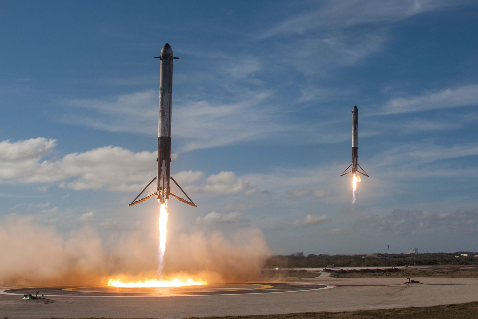 two white flying rockets during daytime